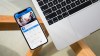 Facebook App Open in iPhone Next to a MacBook
