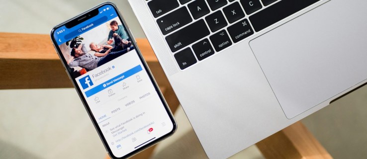 Facebook App Open in iPhone Next to a MacBook