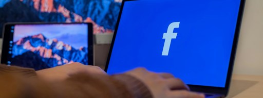 Person accessing Facebook on a Laptop.
