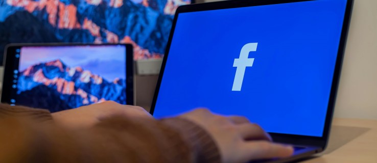 Person accessing Facebook on a Laptop.